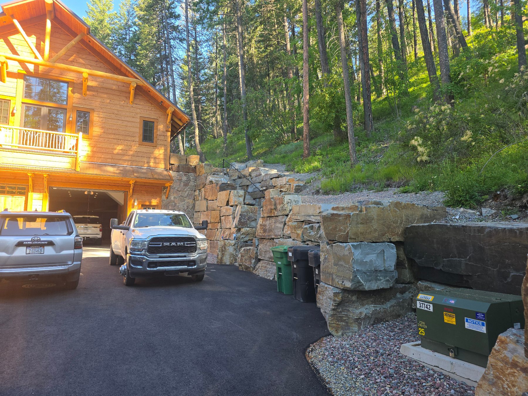Boulder retaining wall with stone steps